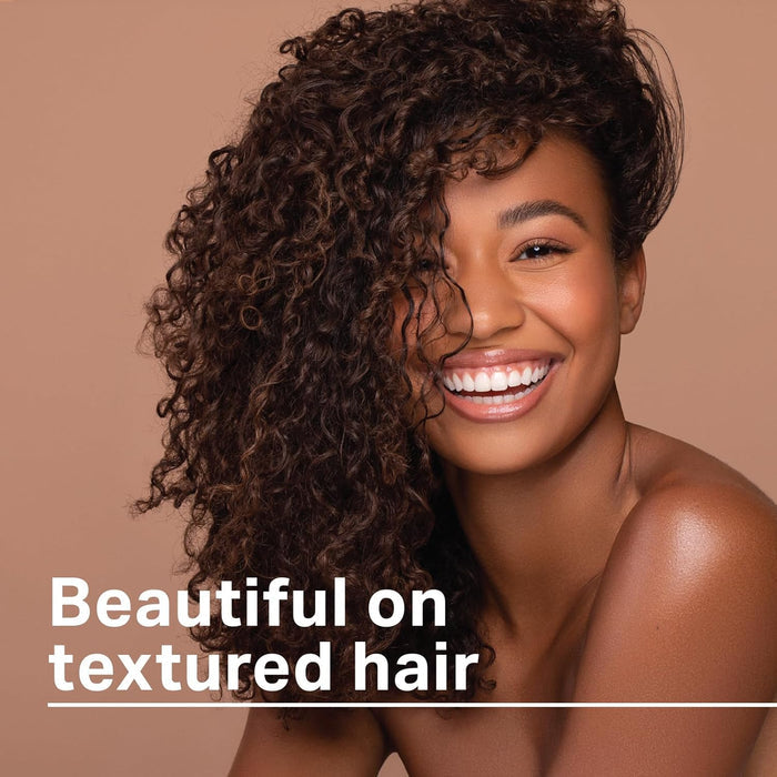 Woman with defined, shiny textured curls styled using Ampro Shine ’n Jam Black Castor and Flaxseed Oil Styler for smooth, healthy-looking natural hair