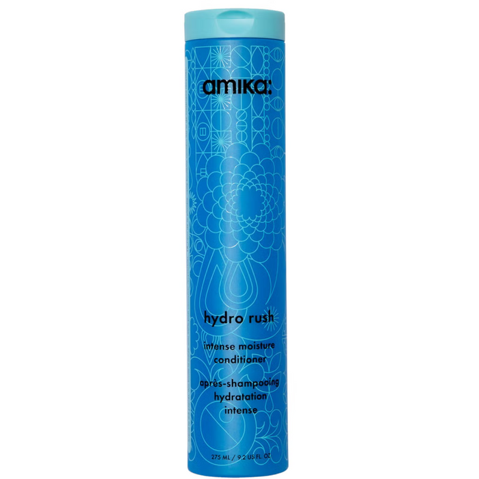 A tall, slender blue bottle of Amika Hydro Rush Intense Moisture Conditioner with a geometric pattern design.