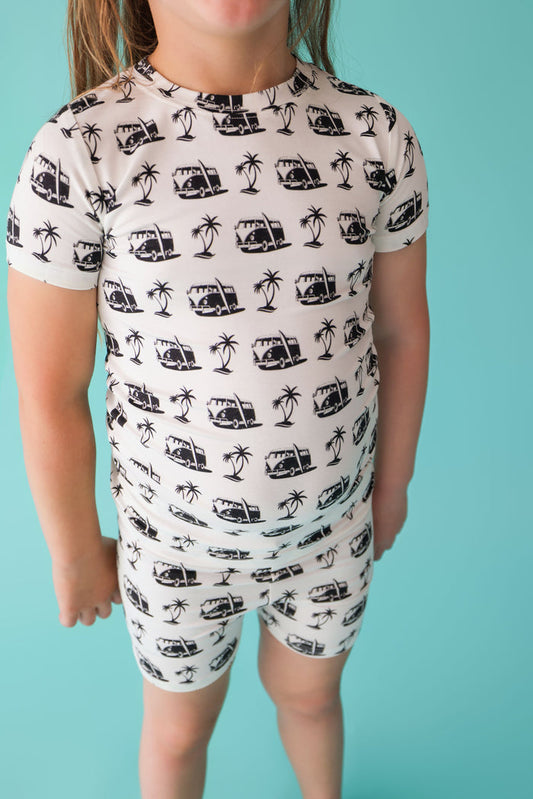 Cream short set with black van and palm tree print throughout shirt and shorts.