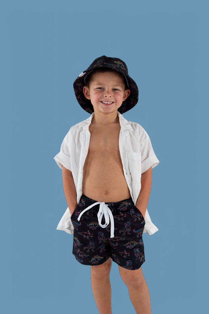 Black swim trunks with colorful dinosaur outline print and white drawstring tie.