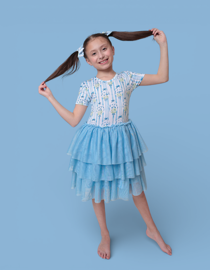 Girl's short-sleeve dress with blue floral print bodice and tiered blue tulle skirt.