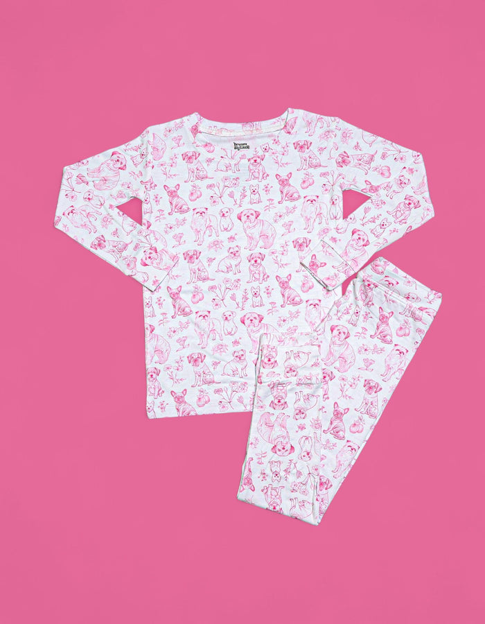White long-sleeve top and pants with pink puppy and floral toile print, cutout details on sleeves.
