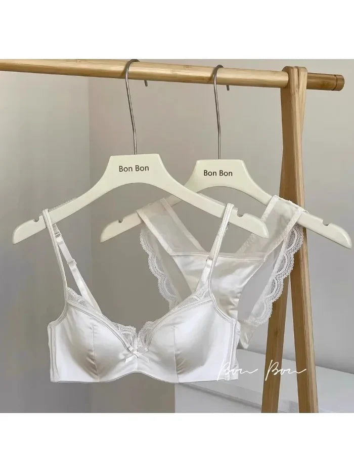 White lace bra on a hanger with 'Bon Bon' branding against a neutral background